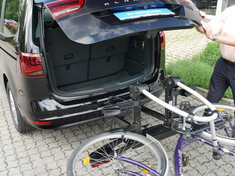 abgeklapptes Fahrrad auf Kupplungsträger mit offenem Kofferraum